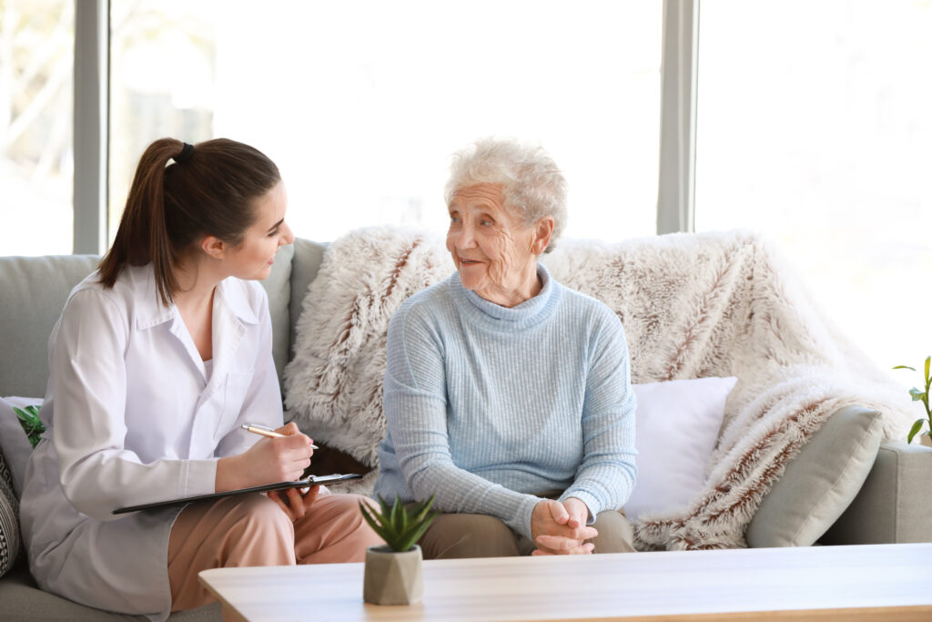 Doctor with senior woman in nursing home